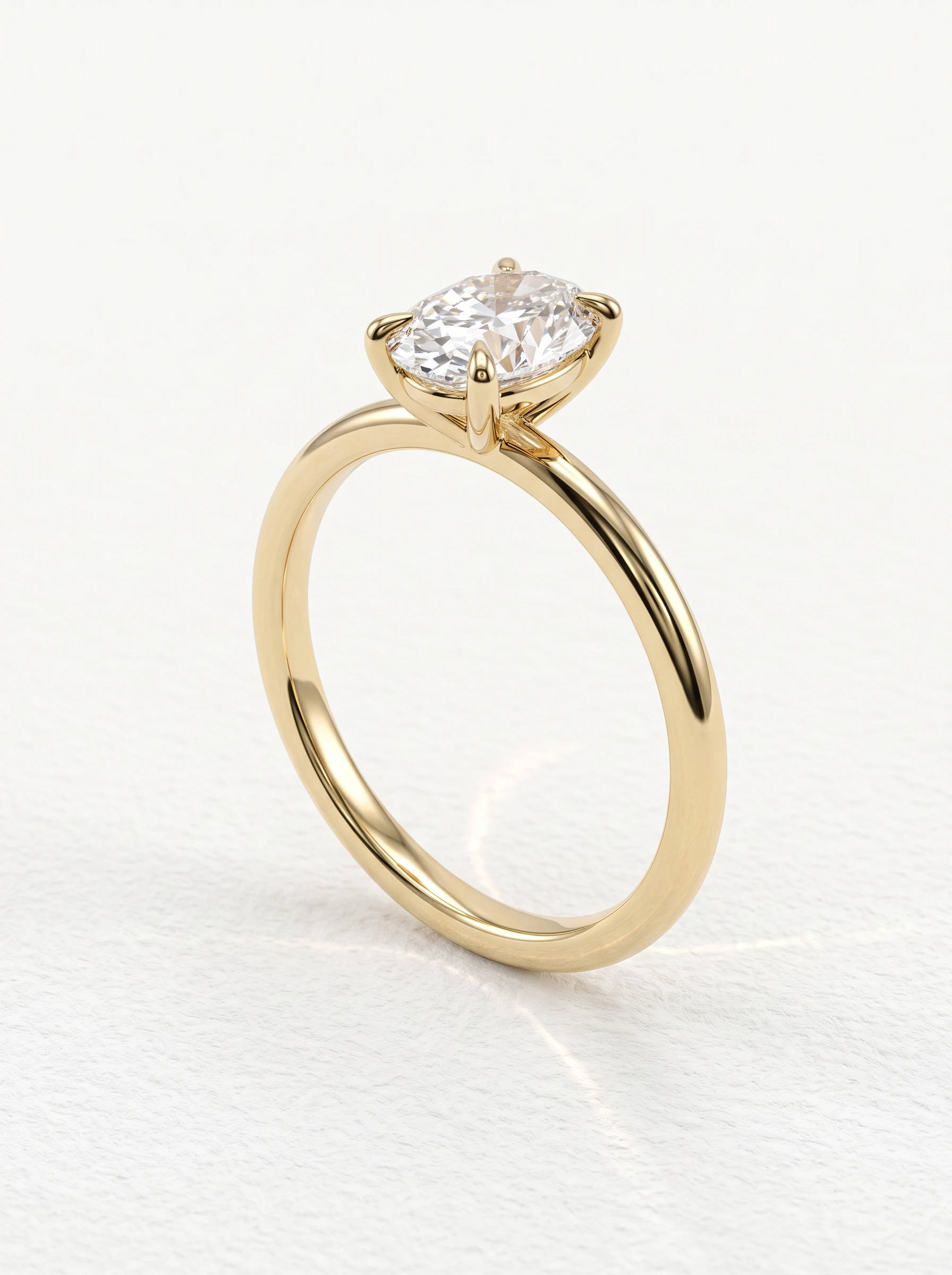 Oval solitaire engagement ring in yellow gold standing upright, four claw prongs on a thin polished band