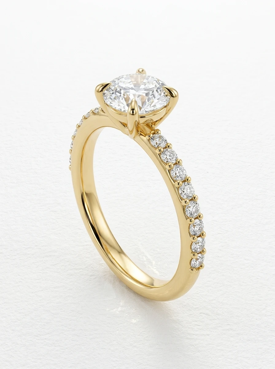 Round brilliant pave engagement ring in yellow gold standing upright, four claw prongs and diamond-set shoulders