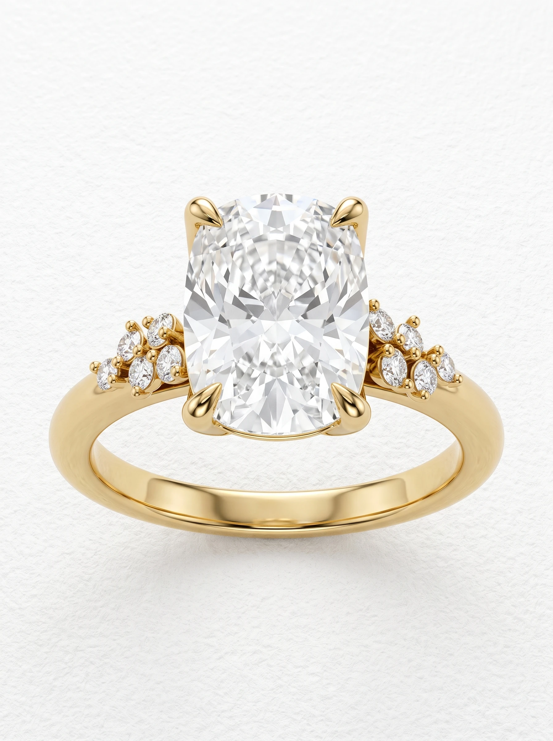 Elongated cushion tulip head engagement ring in yellow gold, front view with four claw prongs and cluster shoulders