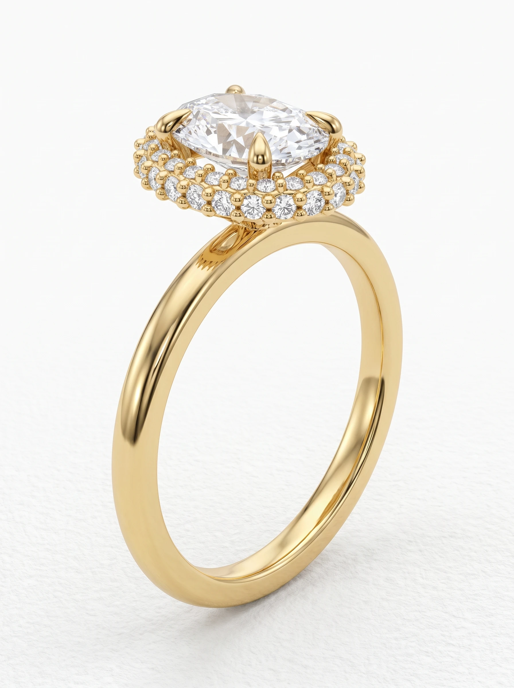 Oval double halo engagement ring in yellow gold standing upright, four claw prongs and a slim polished band